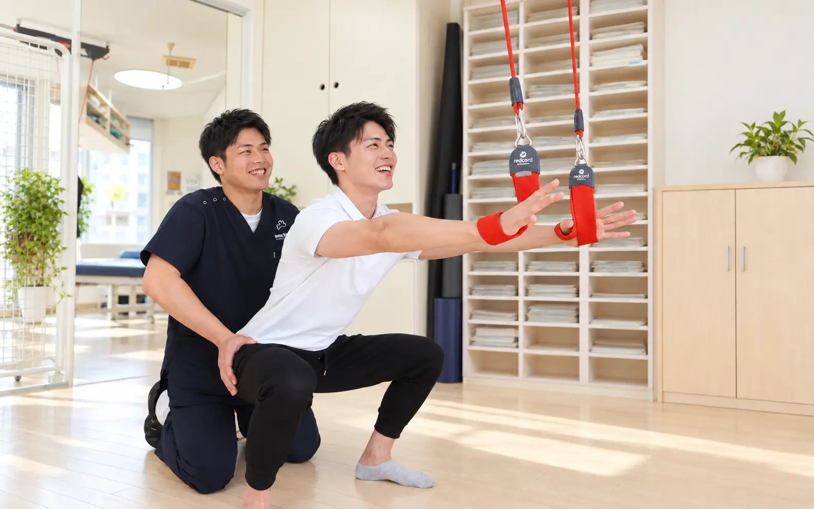 明るい院内で患者様の動きを笑顔で支える柔道整復師